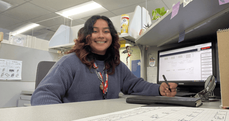 Mayra at her desk